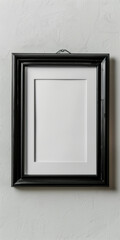 Empty black frame hanging on a textured wall with minimalistic design