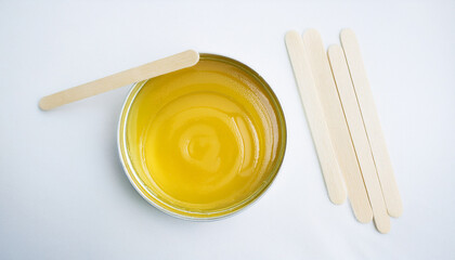 Professional hot wax for depilation with wooden applicator strips. Sugar paste. Beauty and skincare