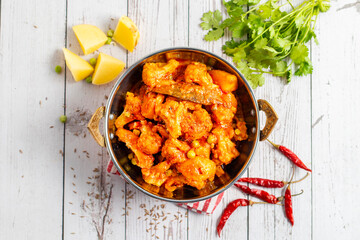 Aloo Phulkopir Dalna is a Bengali potato and cauliflower curry, cooked with spices, tomatoes, and ginger in a rich gravy.