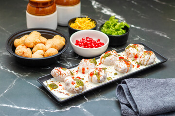Dahi Bhalla is a popular Indian snack made of deep-fried lentil dumplings soaked in creamy yogurt, topped with tangy chutneys, spices, and pomegranate.