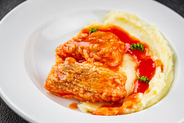 Fish dish tomato sauce and mashed potatoe tasty fresh gourmet food background table rustic food top view copy space
