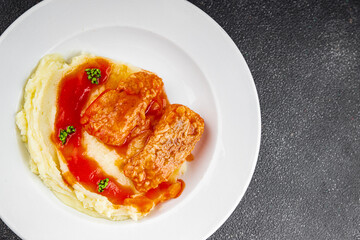 Fish dish tomato sauce and mashed potatoe tasty fresh gourmet food background table rustic food top view copy space