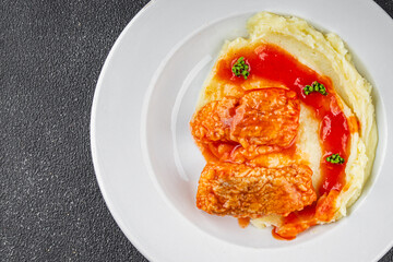 Fish dish tomato sauce and mashed potatoe tasty fresh gourmet food background table rustic food top view copy space