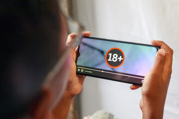 Person Watching 18 Plus Content on Smartphone