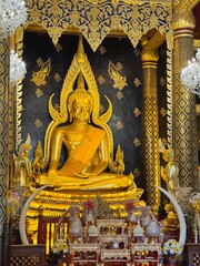 The beautiful decorated altar with golden statue of Buddha in the temple in Thailand
