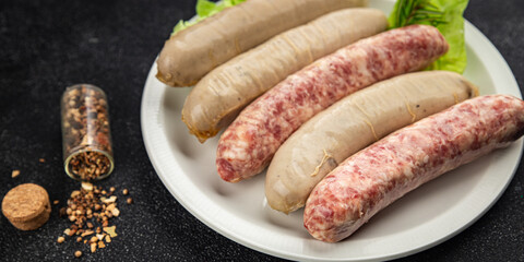 Sausages raw meat pork, beef, chicken, lamb fresh tasty food dish gourmet food background on the table rustic food top view copy space