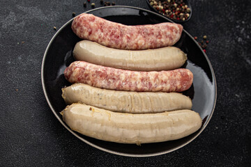 Sausages raw meat pork, beef, chicken, lamb fresh tasty food dish gourmet food background on the...