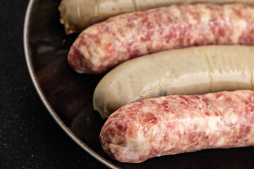 Sausages raw meat pork, beef, chicken, lamb fresh tasty food dish gourmet food background on the table rustic food top view copy space