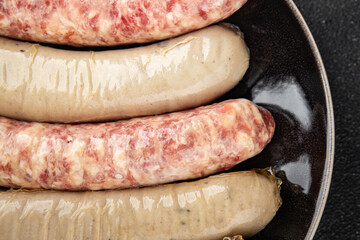 Sausages raw meat pork, beef, chicken, lamb fresh tasty food dish gourmet food background on the table rustic food top view copy space