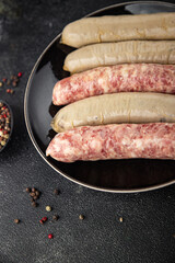 Sausages raw meat pork, beef, chicken, lamb fresh tasty food dish gourmet food background on the table rustic food top view copy space