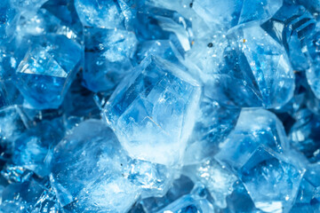 Blue Crystal Mineral Stone. Gems. Mineral crystals in the natural environment. Texture of precious and semiprecious stones. Seamless background with copy space colored shiny surface of precious stones