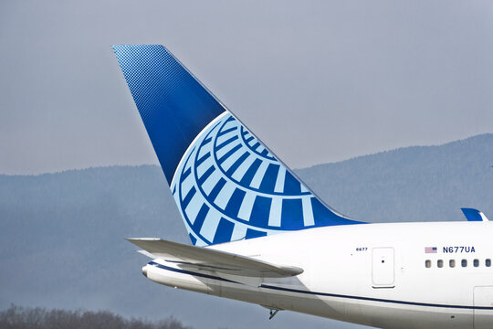 Geneva, Switzerland - march 08, 2025 :sign and logo on a Boeing 767 - 300 of United Airlines plane on the runway with the snow-capped mountains in the background at Geneva airport