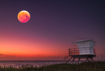 A lunar fantasy composite of a beach scene with a life guard shack and the blood moon from the lunar eclipse of March 14, 2025. All photos taken on Hutchinson Island, Florida.