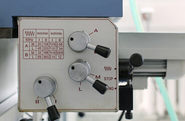 Lathe machine control panel. A close-up of a lathe machine control panel with feed adjustment levers. 