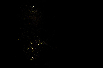 Golden blurred bokeh lights on black background. Glitter sparkle stars for celebrate. Overlay for...