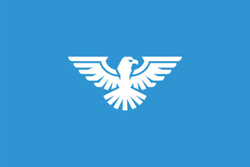 A white eagle, symbolizing freedom and strength, set against a blue background. The eagle is depicted in a spread-winged position, with its talons gripping a circular object,