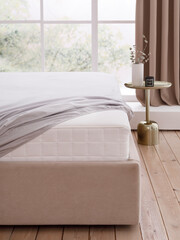 Double bed in the modern interior with a white mattress, covered with a grey fitted sheet in front of a large window. The corner of the mattress is visible. Front view photo. Suitable for mockups.