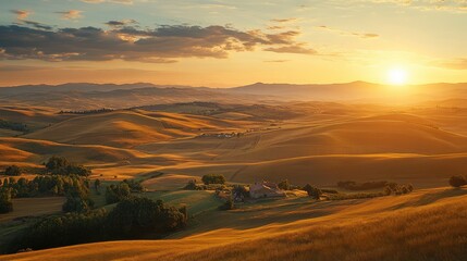 Obraz premium Vast farmland with rolling hills in the distance and the sun setting behind, ideal for promoting domestic rural tourism.