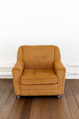 brown armchair textured wall cozy neutral