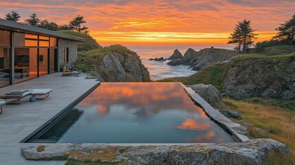 Coastal infinity pool with dramatic sunset views. Modern home on a cliff overlooking the ocean