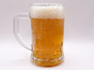 Glass of wheat beer, on a white background, side view