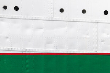 Vintage white ship hull with red green waterline