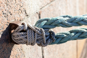 Detailed close-up photo of a securely tied nautical rope knot a