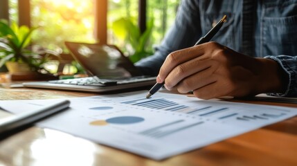 Fototapeta premium Analyzing Financial Data: Businessperson reviewing charts and graphs