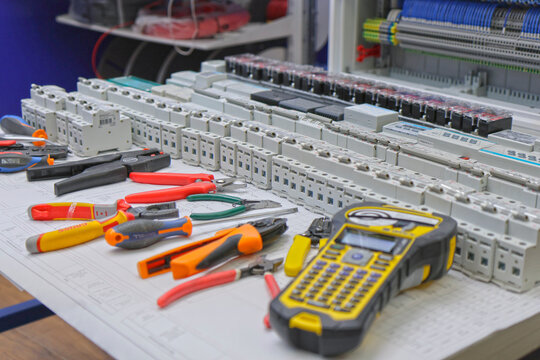 Electrician's workplace for assembling an electrical switchboard. Knipex tools, Weidmuller and EKF current circuit breakers of the Averes AV series. 