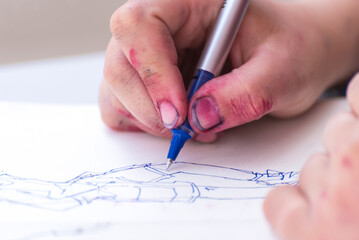close up of hands drawing on a piece of paper, art