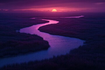 Sunset over winding river in marshland