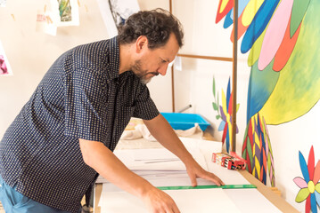 person measuring with a ruler a sheet for architecture, geometry, art, culture