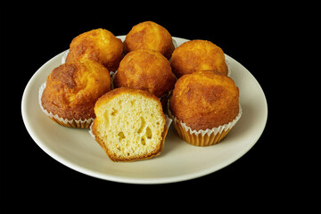 mini muffins on a plate on a black background
