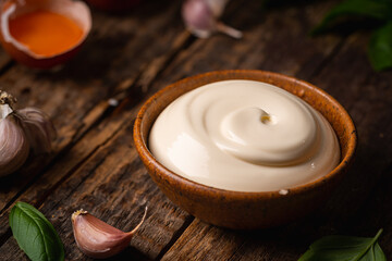 Bowl of Homemade mayonnaise sauce with ingredients and herbs for cooking
