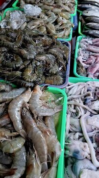 Traders sell mackerel, catfish, red snapper, shrimp, squid and several other freshwater fish to buyers who are bargaining for fish to buy at the traditional market.