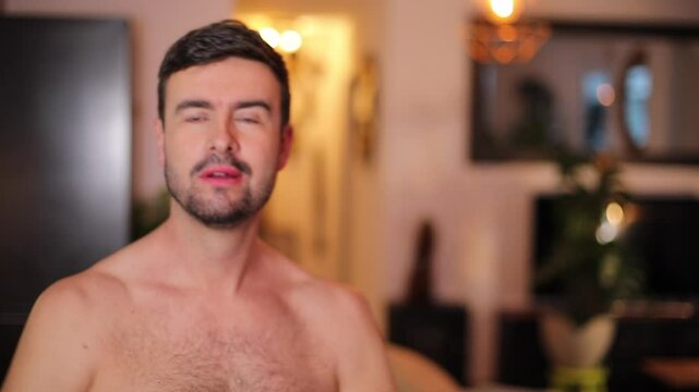 Handsome man taking his shirt off 