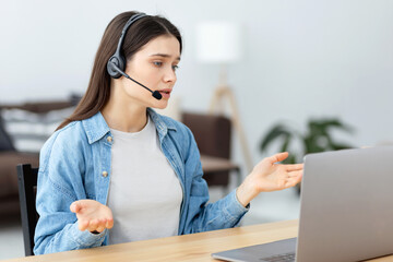 Young woman in headset having online conversation