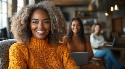 Two young women engage in a collaborative work session at a coffee shop, enjoying a warm atmosphere with cozy seating and modern decor
