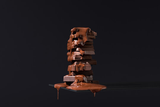 Tower of melting chocolate bars and cookies on dark background