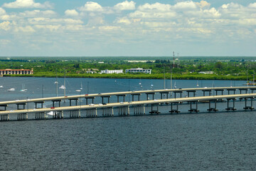 Fototapeta premium Barron Collier Bridge and Gilchrist Bridge in Florida with moving traffic. Transportation infrastructure in Charlotte County connecting Punta Gorda and Port Charlotte over Peace River