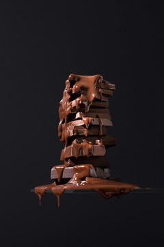 Chocolate cookies drenched in melting chocolate on dark background