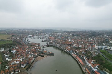 Panorama of Whitby harbor town in England with Gothic cathedral on the hill and sea port view, concept of tourism and historic architecture	
