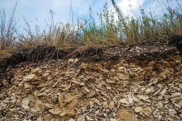 Deposit, quarry for the extraction of sandstone stone. Mining, natural resources. Sandstone, banded, red or brown, colored