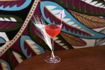 Red Tropical Cocktail with Floral Garnish