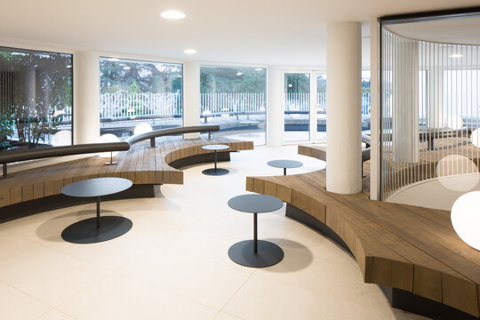 Fototapeta Modern circular seating club area with minimalist black tables