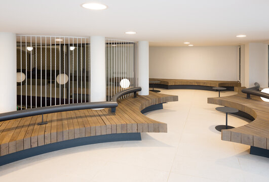 Modern club lobby with circular wooden seating and sleek design