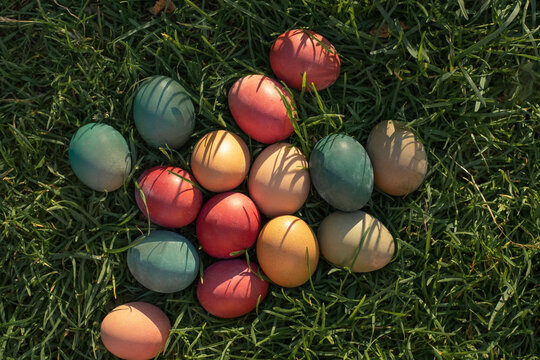 Vibrant easter eggs scattered artistically on grass - Powered by Adobe