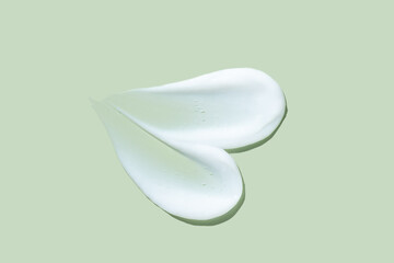 Cream smears on mint green backdrop
