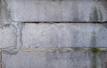 Gray concrete block wall with seams