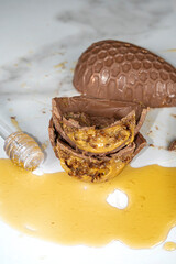 Closeup of Brazilian honey cake filling inside chocolate Easter egg_front view_vertical.